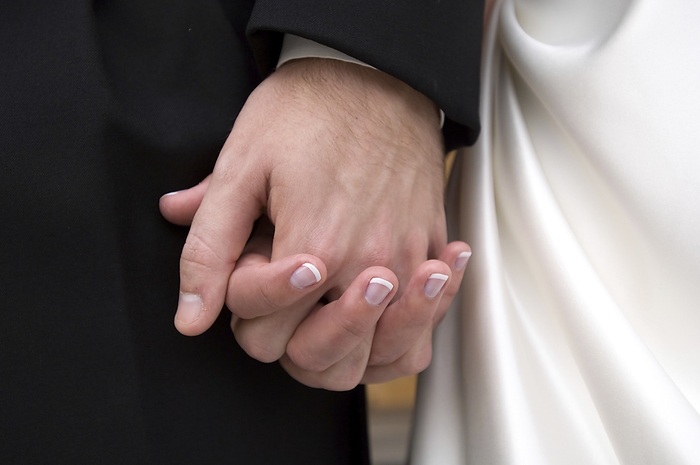 Close-up of a bride and groom holding hands on their wedding day; Lincoln, Nebraska, United States of America, by Joel Sartore Photography / Design Pics