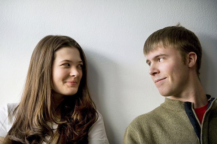 Portrait of young couple against a white wall; Fairbanks, Alaska, United States of America, by Joel Sartore Photography / Design Pics