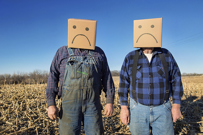 Two farmers wear unhappy box heads; Lincoln, Nebraska, United States of America, by Joel Sartore Photography / Design Pics