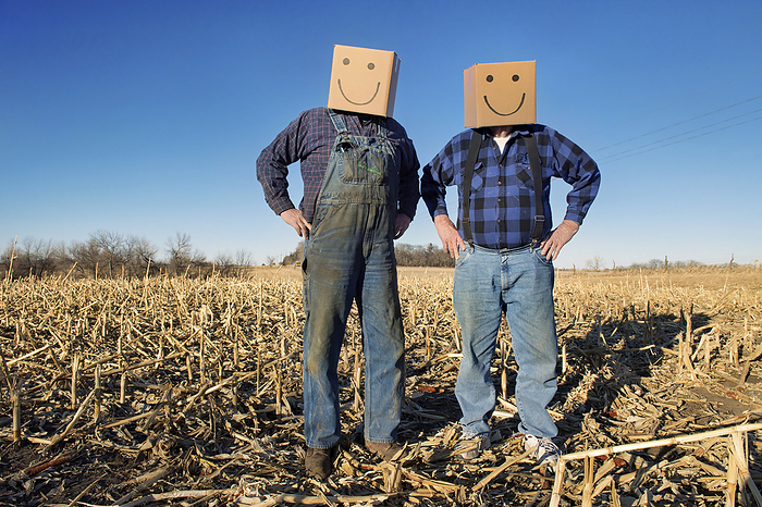 Two farmers wear happy box heads; Lincoln, Nebraska, United States of America, by Joel Sartore Photography / Design Pics