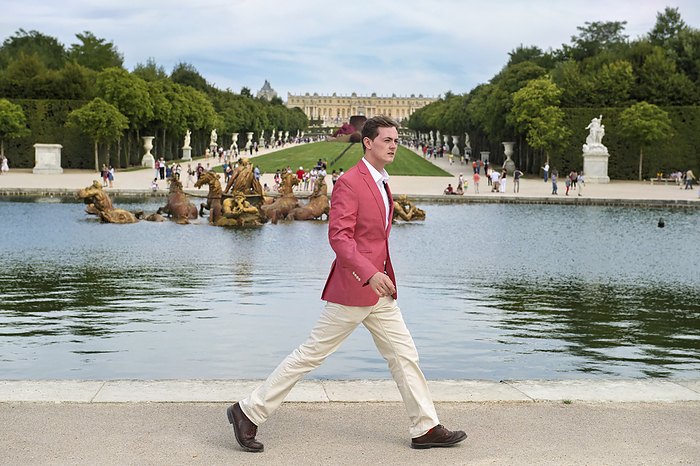 Young man walks in Versailles, France; Versailles, France, by Joel Sartore Photography / Design Pics