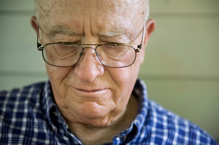 Portrait of an elderly man with eyeglasses looking down; Elkhorn, Nebraska, United States of America, by Joel Sartore Photography / Design Pics