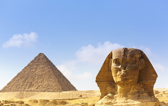 View of the Great Pyramid and Sphinx of Giza under a blue sky; Giza, Cairo, Egypt, by Carson Ganci / Design Pics