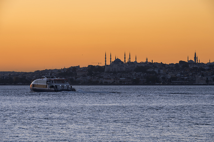 View of the Blue Mosque and Hagia Sophia at sunset from Kadikoy in Istanbul; Istanbul, Turkey, by Dosfotos / Design Pics