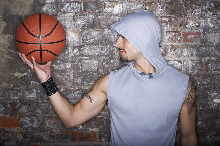 Man Holding Basketball, by Masterfile / Design Pics