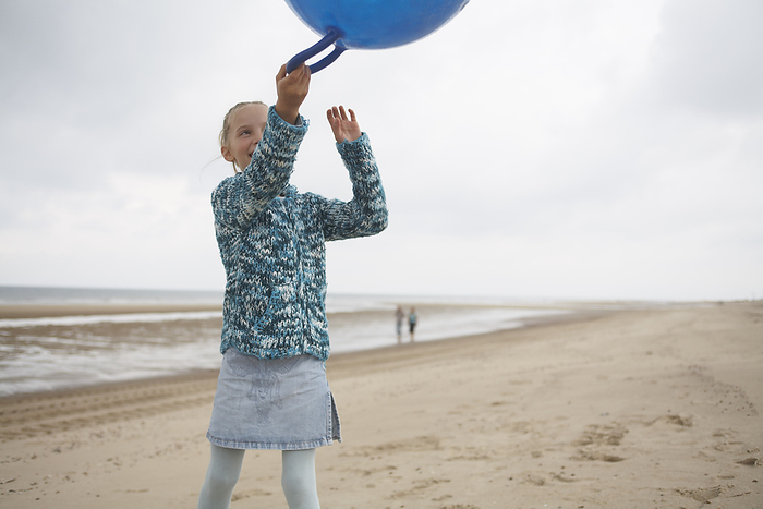 Girl with Space Hopper on Beach, by Masterfile / Design Pics