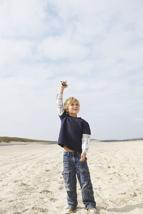 Boy Flying Kite at Beach, by Masterfile / Design Pics