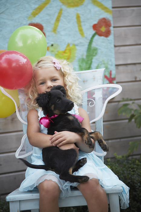 Girl at Birthday Party with Dog, by Masterfile / Design Pics