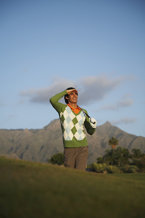 Man Golfing, by Masterfile / Design Pics