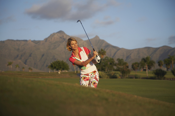 Woman Golfing, by Masterfile / Design Pics