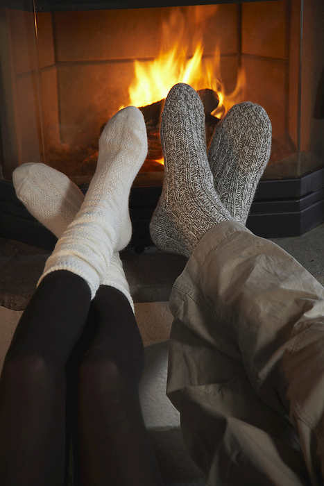 Couple's Feet by Fireplace, by Masterfile / Design Pics