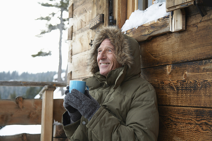 Man Drinking Hot Chocolate in Winter, by Masterfile / Design Pics