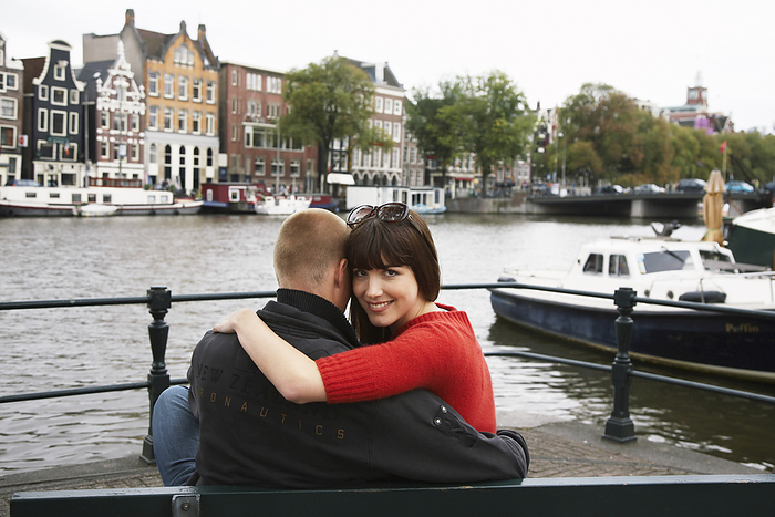 Couple by Canal, Amsterdam, Netherlands, by Masterfile / Design Pics