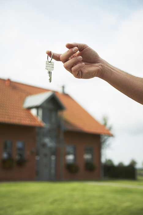 Person Holding House Keys, by Masterfile / Design Pics