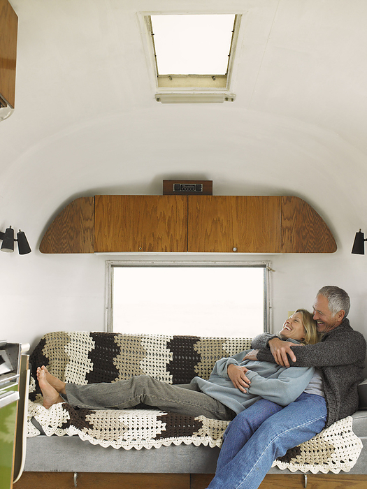 Couple Lying Down in Camper, by Masterfile / Design Pics