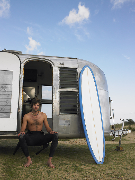 Portrait of Man Sitting on Camper, by Masterfile / Design Pics