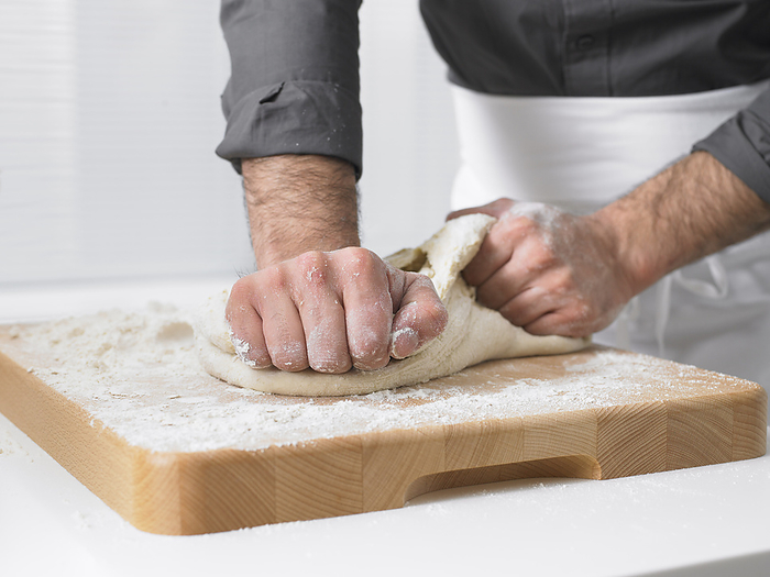 Man Kneading Dough, by Masterfile / Design Pics