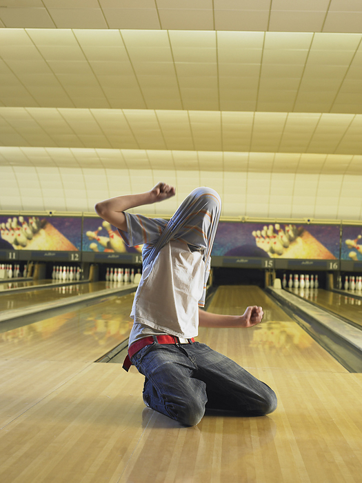 Man at Bowling Alley, by Masterfile / Design Pics