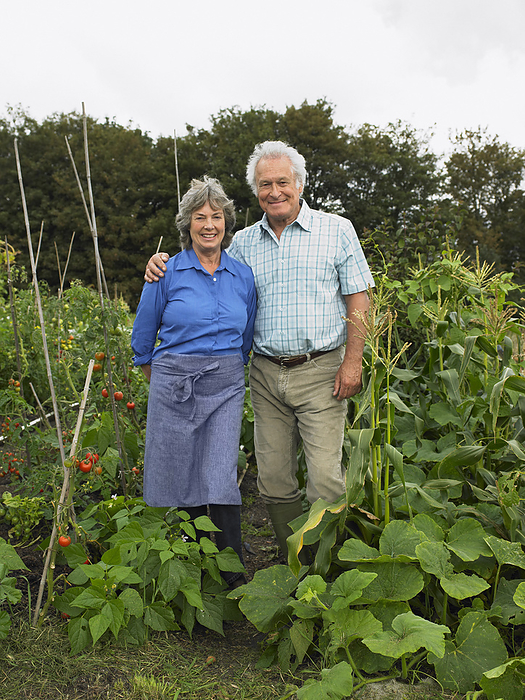 Portrait of Couple in Vegetable Garden, by Masterfile / Design Pics
