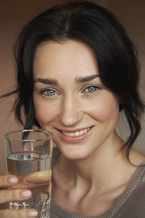 Woman With A Glass Of Water, by Masterfile / Design Pics