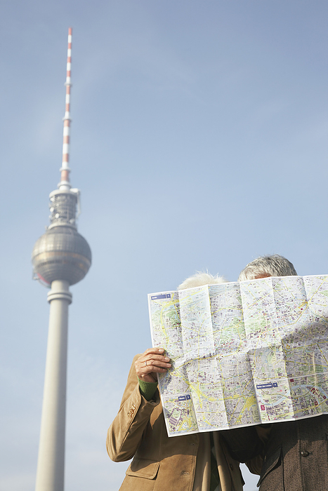 Tourists Looking at Map in Front of the Fernsehturm, Berlin, Germany, by Masterfile / Design Pics