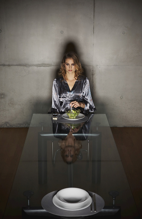 Woman at Dining Room Table, by Masterfile / Design Pics