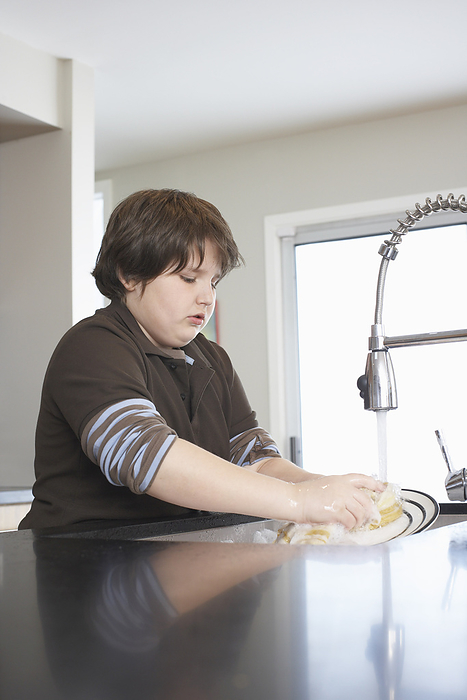 Boy Washing Dishes, by Masterfile / Design Pics