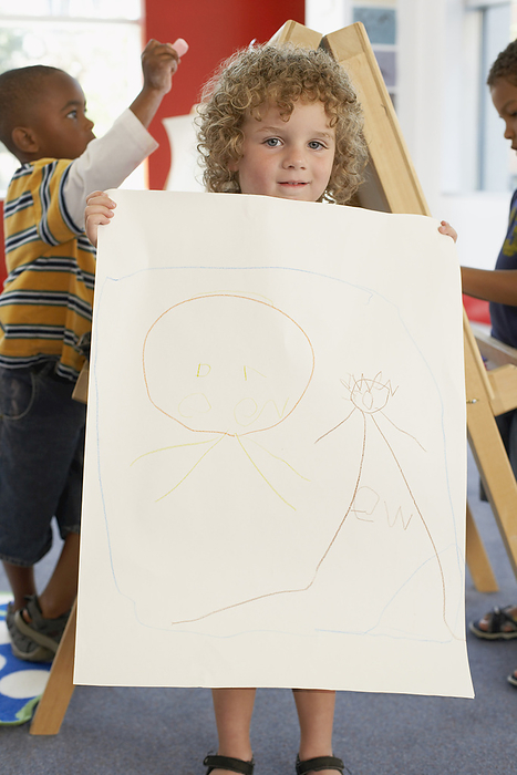 Child Showing Artwork at Daycare, by Masterfile / Design Pics