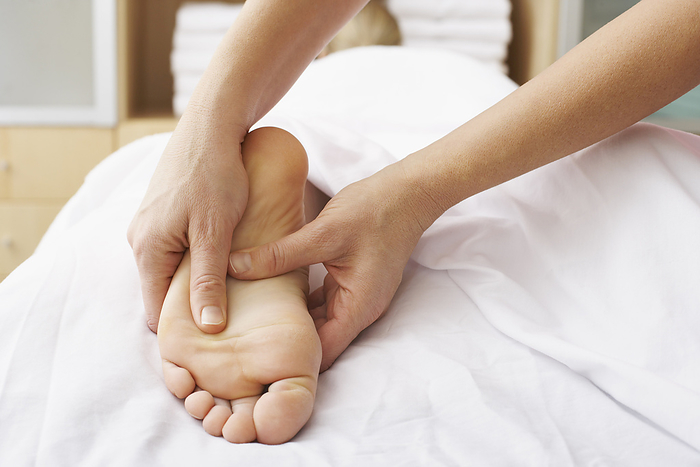 Close-up of Woman's Foot being Massaged, by Masterfile / Design Pics