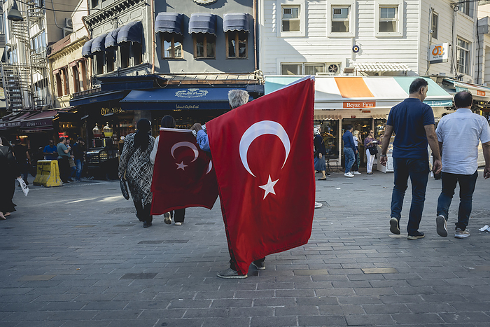 Man selling Turkish flags in Kadikoy, Istanbul; Istanbul, Turkey, by Dosfotos / Design Pics