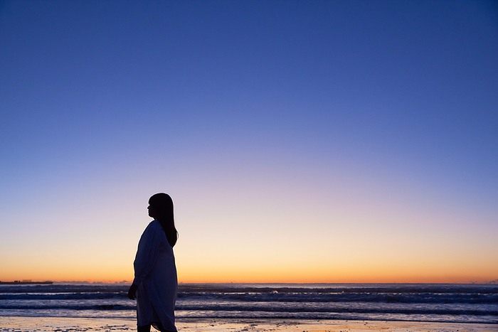 Silhouette of a woman standing on the beach