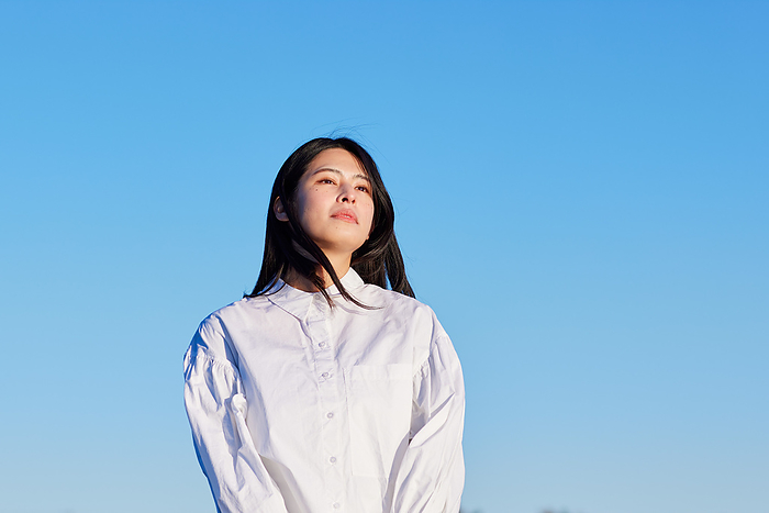 Japanese woman looking at the blue sky and the distance