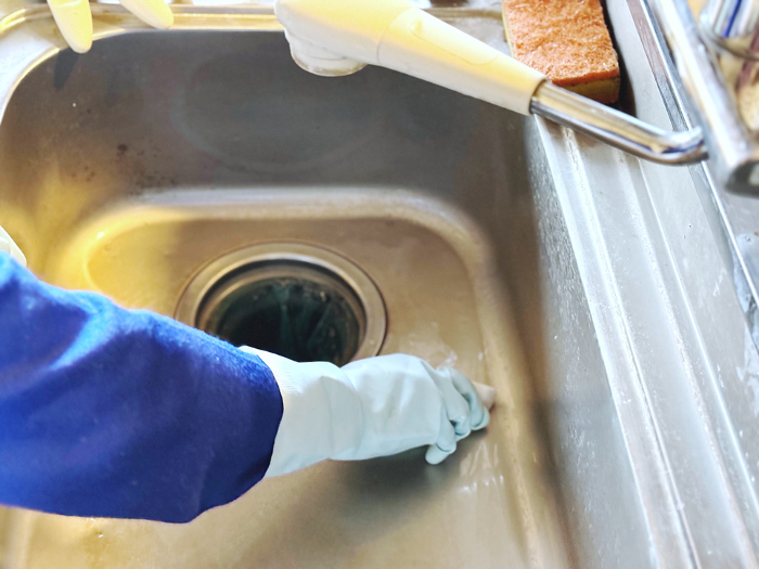 Rubber gloves on hand to clean sink