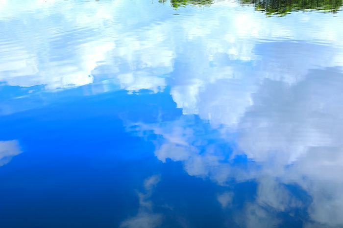 The surface of the water with the sky reflected in it