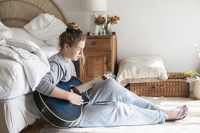 teenage girl playing guitar and singing Teenage girl  16 17  playing guitar in bedroom, by Marc Romanelli