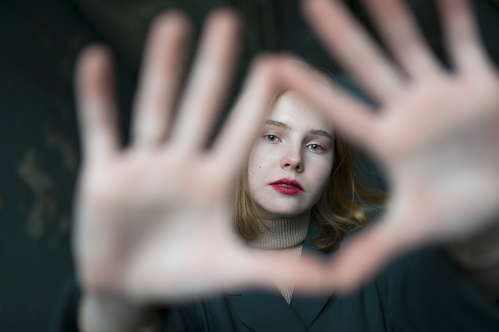 Portrait of teenage girl (16-17) making finger frame, by Vyacheslav Chistyakov