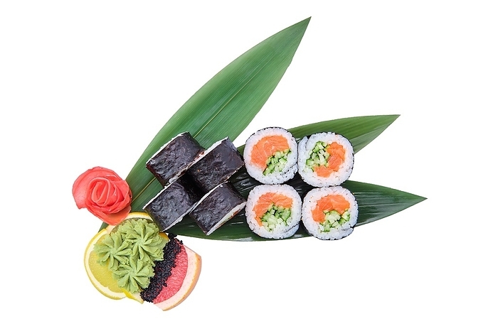 Overhead view of sushi roll with raw salmon fillet with cucumber served on bamboo leaves, by Aleksei Isachenko