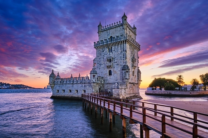 Belem Tower or Tower of St Vincent, famous tourist landmark of Lisboa and tourism attraction, on the bank of the Tagus River Tejo in evening dusk after sunset with dramatic sky. Lisbon, Portugal, Europe, by Dmitry Rukhlenko