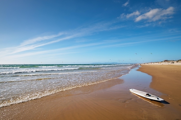 Sandy Atlantic ocean beach with surfboard at Fonte da Telha beach, Costa da Caparica, Portugal, Europe, by Dmitry Rukhlenko