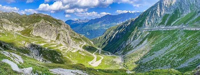 PanoramafoView of old southern pass road Tremola south ramp with serpentines narrow hairpin bends on steep mountain slope of Gotthard Pass on left, gallery on right protected from falling rocks covered new pass road to Airolo, Gotthard Pass, Passo San Gottardo, Canton Uri, Switzerland, Europe, by Frank Schneider