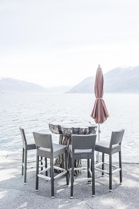 Chair and Table on the Waterfront with Mountain in Ascona, Ticino, Switzerland, Europe, by Mats Silvan