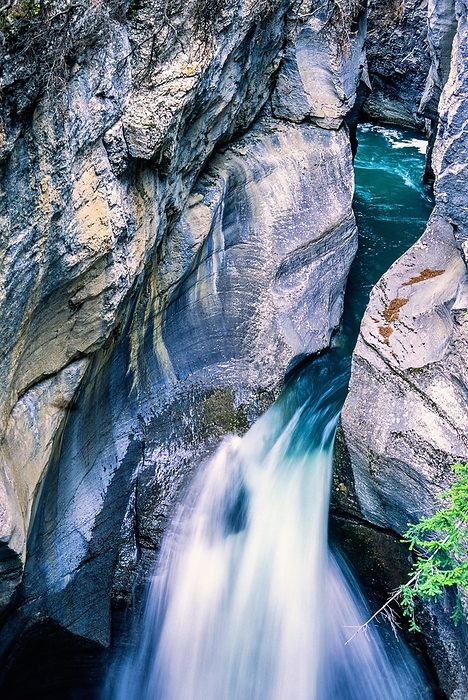 Beautiful waterfall in a canyon between the rock faces, Jasper National Park, Canada, North America, by Lars Johansson