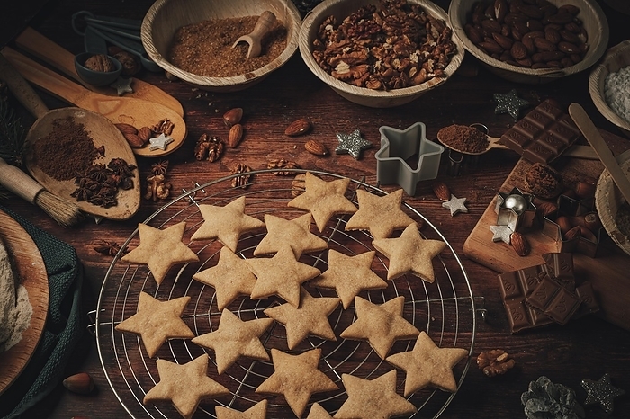Cinnamon stars baked on a cake rack, baking ingredients, flour, sugar, almonds, nuts, chocolate, cinnamon, cookie cutters, by Lucas Seebacher