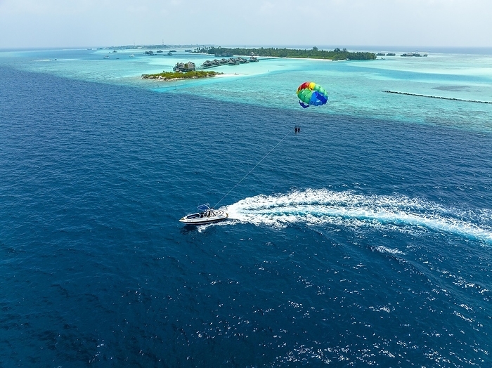 Aerial View, Maldives, North Male Atoll, Paraglider at Paradise Island with Water Bungalows, Asia, by Martin Moxter