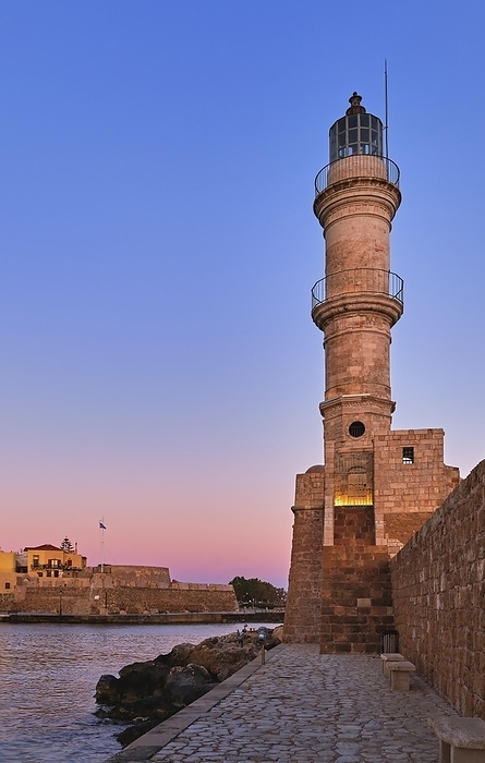 Egyptian Lighthouse of Old Venetian harbour of Chania, Crete, Greece at sunrise. Great sky colors from blue to pink, vertical shot against Firka castle walls, by Natallia Pershaj