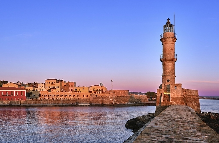 Egyptian Lighthouse of Old Venetian harbour of Chania, Crete, Greece at sunrise. Soft sky colors from blue to pink, Firka castle walls and Maritime museum of Crete in background, by Natallia Pershaj