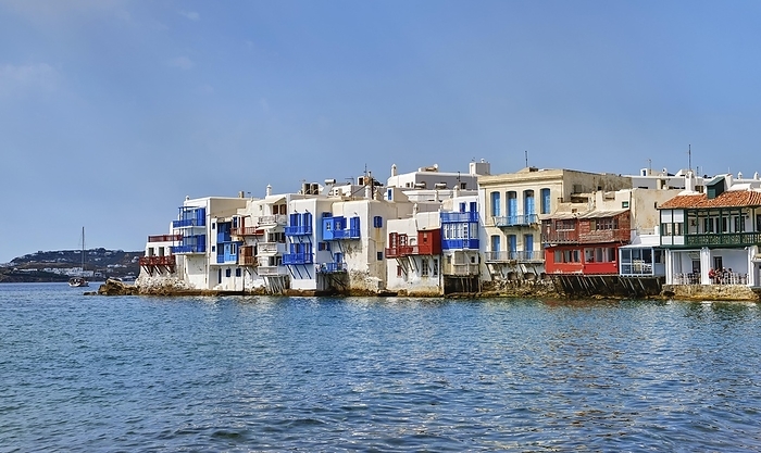 Seafront Little Venice of Mykonos main town or Chora, Cyclades, Greece. Romantic neighborhood with bars, cafes, restaurants in whitewashed old fisherman houses hanging on cliffs above sea waves, by Natallia Pershaj
