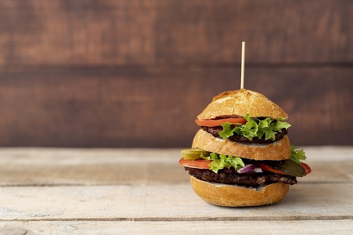 Front view burger with wooden background, by Oleksandr Latkun