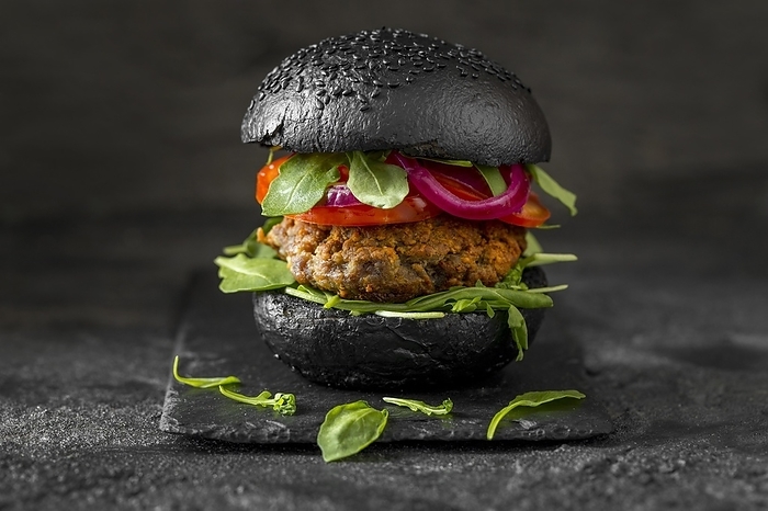 Front view veggie burger with black buns, by Oleksandr Latkun