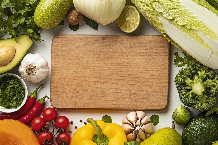 Top view assortment vegetables with chopping board, by Oleksandr Latkun